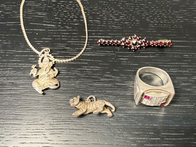 a necklace, bracelet, and ring sitting on a table