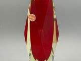 a glass vase with a red flower inside of it