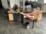a desk with two monitors and a keyboard on it