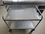 a metal cart with a tray on it in a kitchen