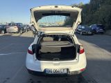a white car with its trunk open in a parking lot