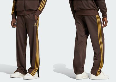 a man in a brown track suit standing next to another man in white shoes