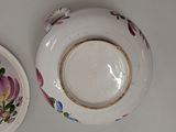 two plates with flowers painted on them on a table