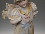 statue of a little girl holding a bird in her hands