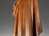 a wooden statue of a man with a beard and a robe