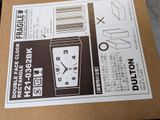 a box with a clock inside of it sitting on a table