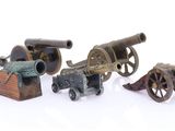 four different types of toy cannon on a white surface