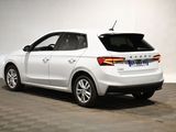 the rear end of a white car parked in a garage
