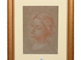 a drawing of a woman ' s face in a gold frame