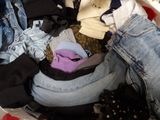 a pile of clothes that is sitting in a basket