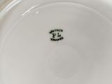 a close up of a plate with a green plant on it