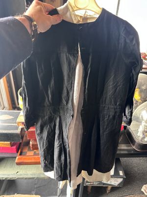 a man that is holding up a shirt on a stand