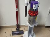 a vacuum that is sitting on the floor next to a vacuum