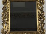an ornate gold framed mirror on a white wall with a black background