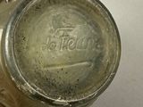a glass jar with a lid on a white surface