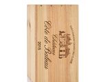 a wooden box with a bottle of wine in it on a white background