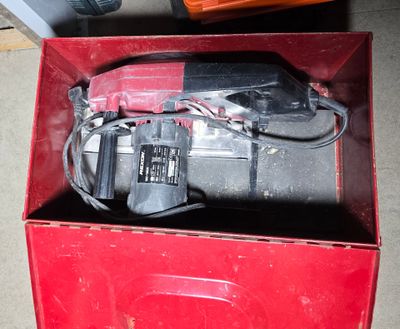 a red box with tools in it sitting on the floor