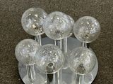 a lot of glass balls that are on a silver plate