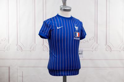 a close up of a blue shirt on a mannequin stand