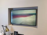 a picture of a flat screen tv mounted on a wall above a desk