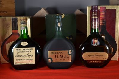 three bottles of liquor sitting on a table next to a box of books