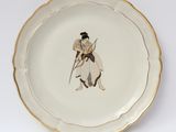a plate with a picture of a woman holding a sword