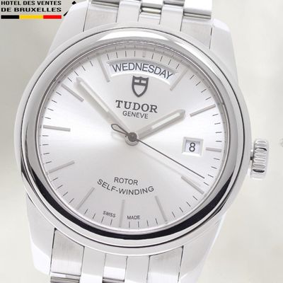 a close up of a wrist watch with a white dial