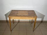 a small wooden table with a chess board on top of it