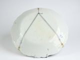 a white plate with a chain hanging from it