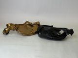 pair of antique brass and black purses on a white surface