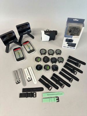 many different types of watches and gadgets laid out on a table