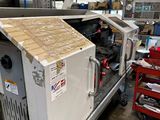 une photo d'une machine dans une usine, avec une boîte en carton à l'arrière