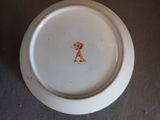 a white plate with a red design on it