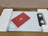 a box that has a red book and a red notebook in it