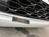 a close up of a car ' s grille with a sticker on it