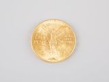 a close up of a gold coin on a white surface