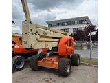 a crane is parked in front of a building on a cloudy day