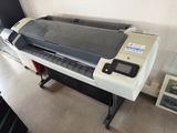 a large printer sitting on a stand in a room