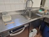 a kitchen with a sink and a dishwasher in it