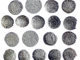 an image of a collection of silver coins on a white surface