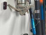 a fishing rod and a reel hanging on a wall