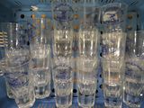 a lot of glasses that are sitting on a shelf