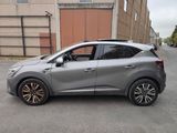 the grey car is parked on the street in front of a building
