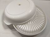 a white dish with a lid on a white plate