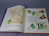 an open book with a picture of a frog on it