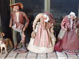 cinq figurines représentant des personnes debout sous un porche