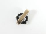 a close up of a black and gold ring on a white surface