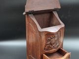 an old wooden cabinet with a drawer underneath it on a black surface