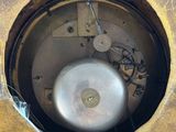 a close up of a clock that is on a table