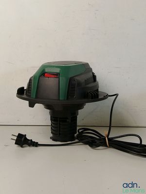 a close up of a green and black blower on a white surface